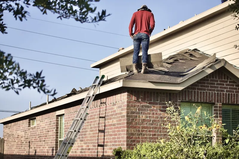 Professional roofer working on a residential roof in Rio del Mar